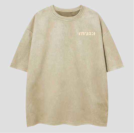 Beige t-shirt with 'MUSH' logo on a light gray background
